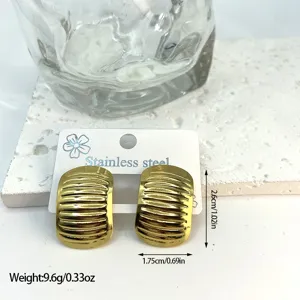 Close-up view of gold stainless steel striped stud earrings with size and weight markers