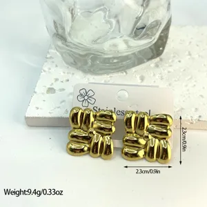 Detail view of gold geometric striped stainless steel earrings with 2.3cm size markings