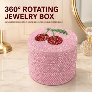 Close-up detail of the 4-layer rotating rhinestone jewelry box featuring a cute cherry top motif.