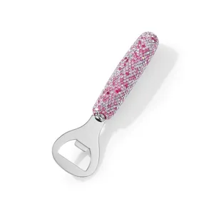 Close-up of pink and white rhinestone-encrusted handle on stainless steel bottle opener