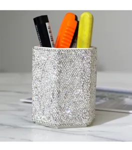 Luxury crystal rhinestone pen holder and makeup brush storage cup for modern office desk decor.