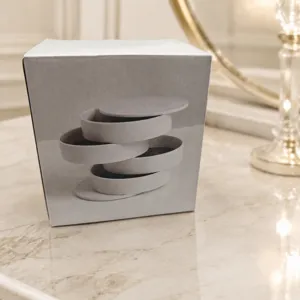4-layer rotating jewelry storage box packaging detail shot, dustproof and elegant desktop organizer.