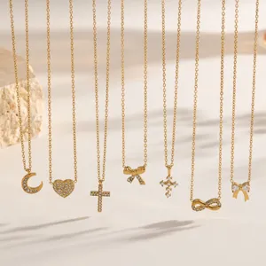 Detail of gold rhinestone pendant necklaces with moon, heart, and cross designs