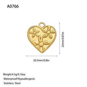 Macro view of gold heart pendant with floral engraving and dimensions