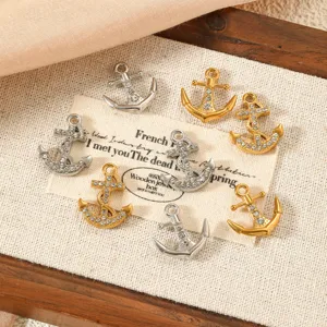Detailed view of silver and gold anchor charms with rhinestones for DIY jewelry