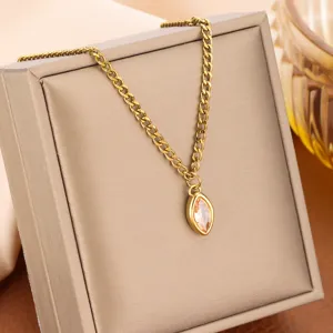 Close-up of gold titanium steel necklace with marquise champagne stone pendant