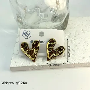 Close-up of gold hammered heart earrings with size and weight measurement data.