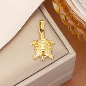 Detailed macro view of gold turtle pendant in polished titanium steel on a jewelry box
