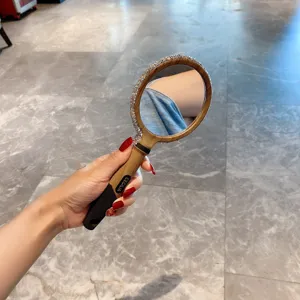 Hand-Kosmetikspiegel mit Strassrahmen und Holzmaserunggriff fuer den taeglichen Gebrauch.