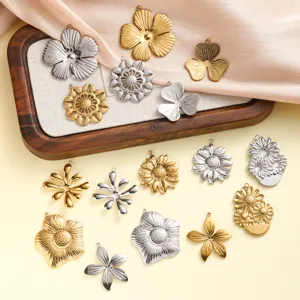 Detailed view of assorted hollow flower stainless steel pendants in gold and silver