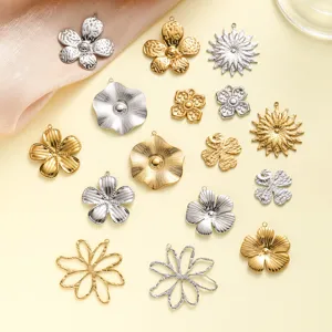 Detailed view of various flower-shaped stainless steel pendants in gold and silver