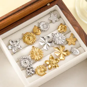 Various stainless steel flower and star pendants in a jewelry display box