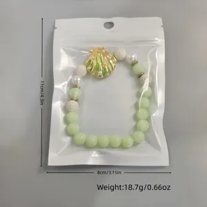 Luminous shell necklace in clear packaging with size and weight specs