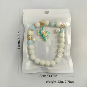 Detailed view of luminous conch pearl pendant bracelet in 11x8cm clear zip packaging