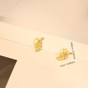Close-up detail showing dimensions of golden grape charms for DIY jewelry making