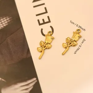 Detailed view of golden stainless steel rose charms with dimensions 2x1 cm.