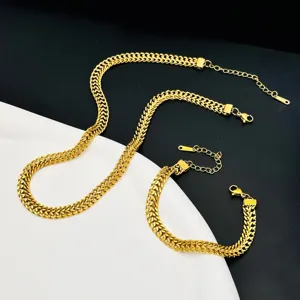Detailed view of a vintage gold chunky chain necklace and bracelet in titanium steel