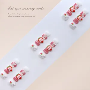Close-up detail of cute pink strawberry and bunny 3D press-on nails for children