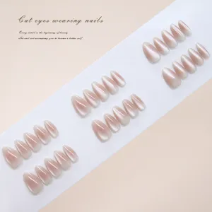 Detail of 30pcs handmade cat eye blush press-on nails arranged on white strip