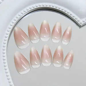 Detailed view of almond-shaped press-on nails with translucent cat-eye blush gradient finish