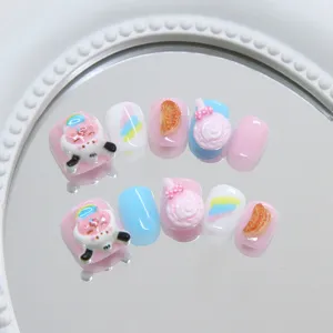 Detailed macro view of 3D children's press-on nails with cute cow and candy designs