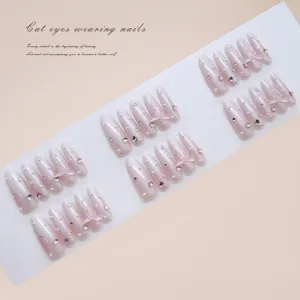 Elegant creamy white gradient press-on nails with pink bows, pearls and heart gems