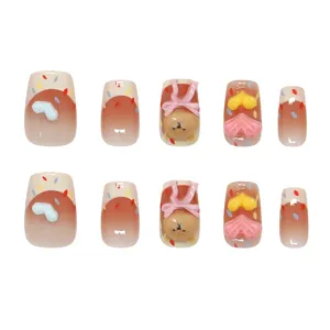 Handmade press-on nails featuring 3D cream bear, hearts and colorful candy dots