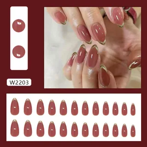Elegant almond press-on nails with gold glitter French tips in a mauve finish