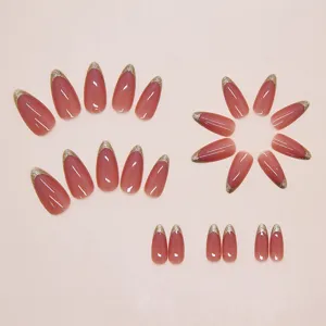 Detail view of mauve pink press-on nails with fine gold glitter French tips, 24 pieces set