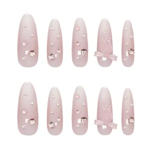 Elegant handmade pink gradient press-on nails with 3D bows, pearls and heart charms