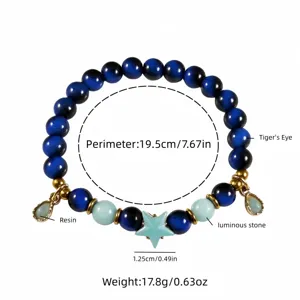 Close-up detail of ocean style luminous bracelet with tiger's eye and star charm