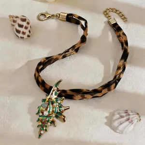 Detailed macro view of luminous sea shell pendant with pearls and leopard print strap