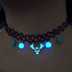 Close-up of a glowing Halloween skull choker with luminous beads and crosses detail