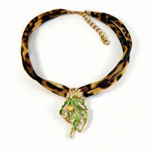 Detailed view of luminous jellyfish pendant with leopard print silk ribbon and pearls