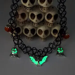 Macro view of glowing ghost and bat charms on a black elastic Halloween fishnet choker necklace