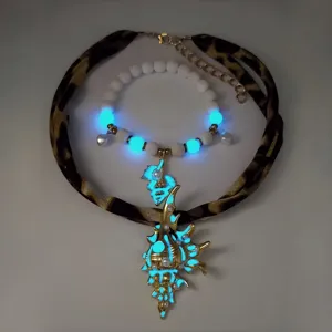 Detailed view of luminous conch pendant necklace and bracelet set with glowing effect
