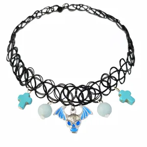 Macro view of black elastic tattoo choker featuring blue bat skull and cross charms