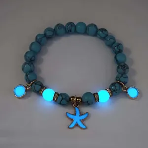 Detailed view of luminous blue beaded bracelet with glowing starfish charm