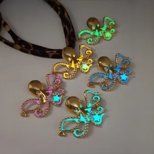 Detail of luminous octopus pendants showing various glow colors and pearl accents