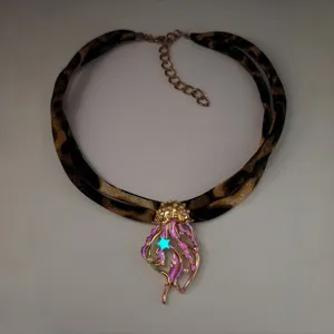 Luminous jellyfish pendant on leopard print ribbon necklace with pearl details