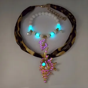 Glow in the dark conch necklace and beaded bracelet set showing luminous details