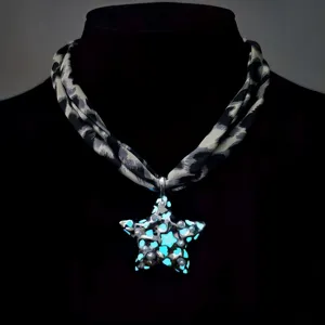 Close-up of leopard print necklace with glowing star pendant and pearl embellishments.