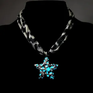 Detailed macro view of a luminous star pendant with leopard print ribbon cord necklace