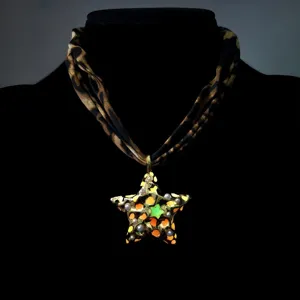 Detailed view of luminous pentagram pendant with vintage leopard print fabric cord