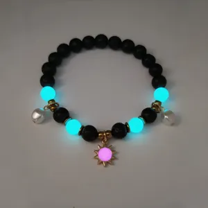 Detail of luminous summer beach necklace featuring glow-in-the-dark sun and shell pendants