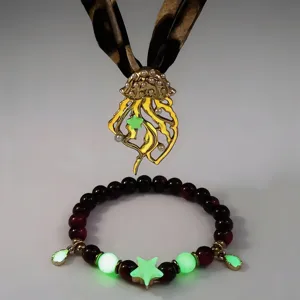 Detailed shot of luminous jellyfish pendant necklace with leopard ribbon and matching beaded bracelet