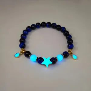Detail of luminous deep sea star bracelet with glowing blue star and bead accents
