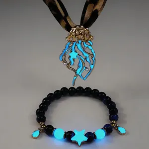 Close-up of glow-in-the-dark jellyfish necklace and bracelet with leopard ribbon