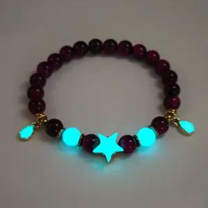 Luminous beaded bracelet featuring glowing star and teardrop charms on dark purple beads