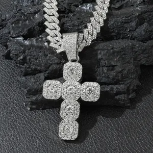 Detailed macro shot of a luxurious iced out cross pendant on a silver Cuban link chain